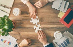 5 Key Ways to Build a Dream Sales Team Sales team collaborating around a table in a meeting