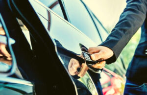 You Should Hire the Best Drivers in Vancouver Why ? Professional chauffeur standing beside a car in Vancouver