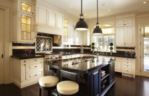 The Importance of Good Lighting in Your Kitchen Remodel Cream-colored kitchen with bright layered lighting fixtures