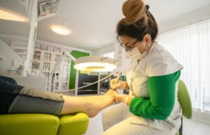 Taking Care of Your Feet with Expertise and Compassion Podiatrist examining a patient's foot during a checkup