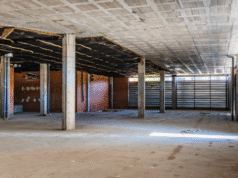 Design-Build vs. Design-Bid-Build: What’s Best for Your Commercial Renovation Project Construction team reviewing commercial renovation blueprints on site